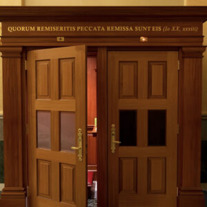 confession-latin-shrine-our-lady-guadalupe-church-la-crosse-wisconsin-gallery Door leading to the confessional with Latin wording above reading "Quorum Remiseritis Peccata Remissa Sunt Eis" at Our Lady of Guadalupe Shrine in La Crosse, Wisconsin.