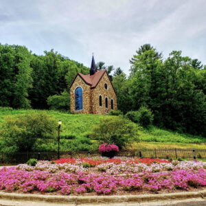 flower-bed-landscape-votive-candle-chapel-shrine-shrine-our-lady-guadalupe-church-la-crosse-wisconsin-gallery The Votive Candle Chapel exterior on top of a hill at Our Lady of Guadalupe Shrine in La Crosse, Wisconsin.