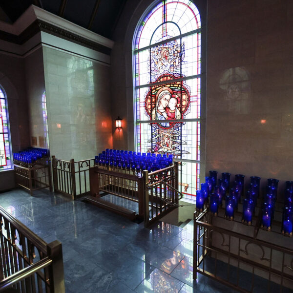 stained-glass-windows-votive-candle-chapel-close-up-candles-shrine-our-lady-guadalupe-church-la-crosse-wisconsin-gallery Stained glass windows and lit up candles in the Votive Candle Chapel at Our Lady of Guadalupe Shrine in La Crosse, Wisconsin.