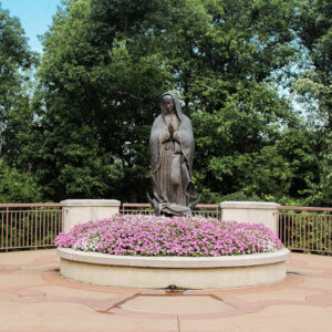 statue-mary-pink-flowers-shrine-our-lady-guadalupe-church-la-crosse-wisconsin-gallery Statue of Mary praying in the garden at Our Lady of Guadalupe Shrine in La Crosse, Wisconsin.