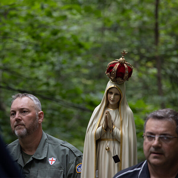 Closeup of two men carrying Our Lady of Fatima statue uphill during procession. Closeup of two men carrying Our Lady of Fatima statue uphill during procession.
