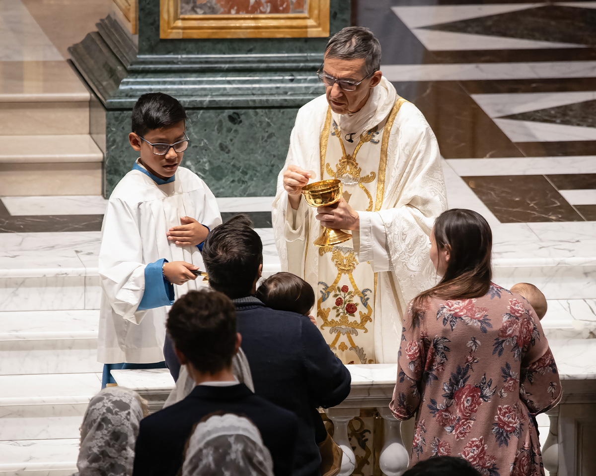 Couple Receiving Communion with children Couple Receiving Communion with children