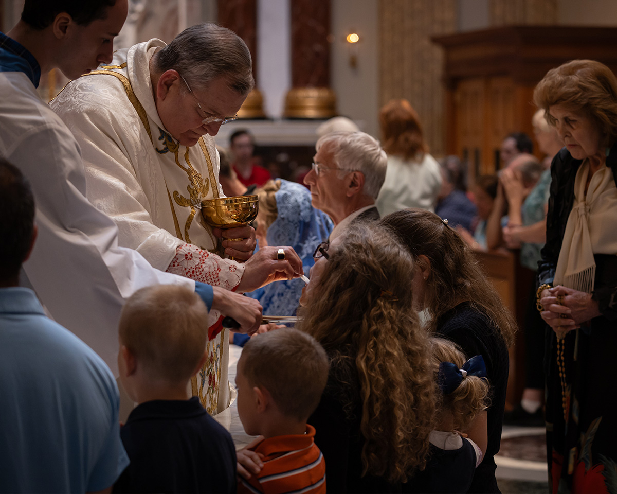 Family Kneeling for the Reception of th Eucharist Family Kneeling for the Reception of th Eucharist