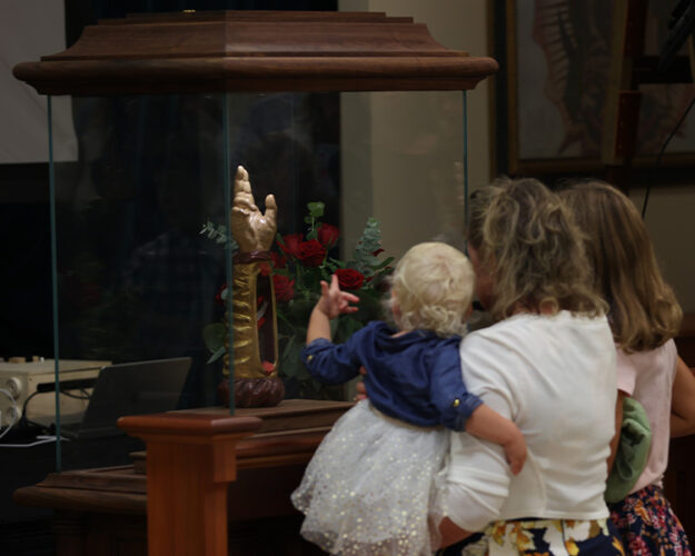 Family venerating the Arm of Saint Jude at the Guadalupe Shrine Family venerating the Arm of Saint Jude at the Guadalupe Shrine