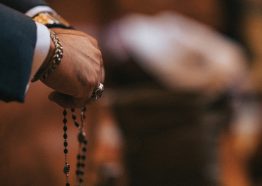 Hands folded in prayer with the rosary Hands folded in prayer with the rosary