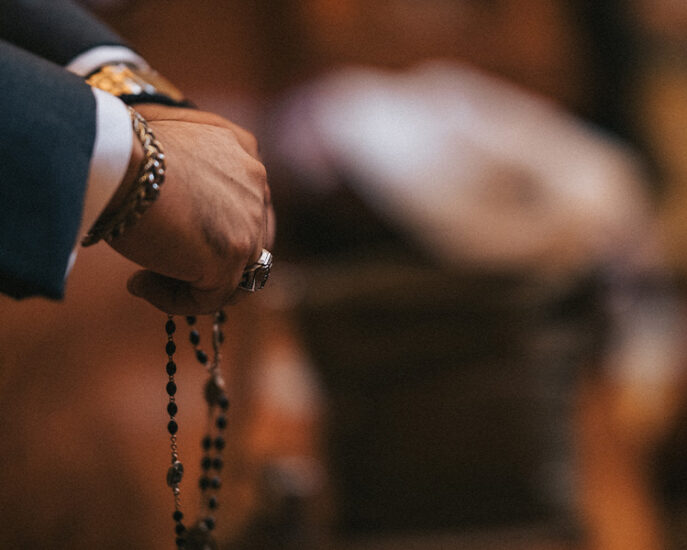 Hands folded in prayer with the rosary Hands folded in prayer with the rosary