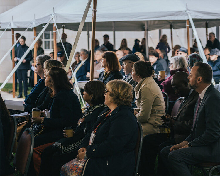 People gathered under the tent for the Pilgrim House ground breaking People gathered under the tent for the Pilgrim House ground breaking