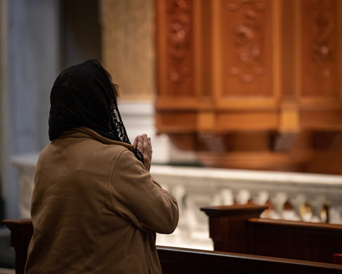 Pilgrim praying in the Shrine Church with black veil Pilgrim praying in the Shrine Church with black veil
