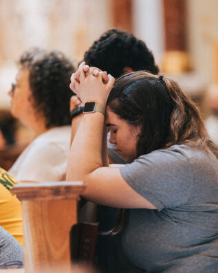 praying young adult praying young adult