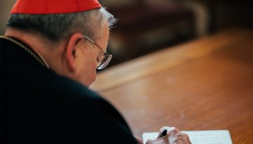 Cardinal Burke Signing a Letter
