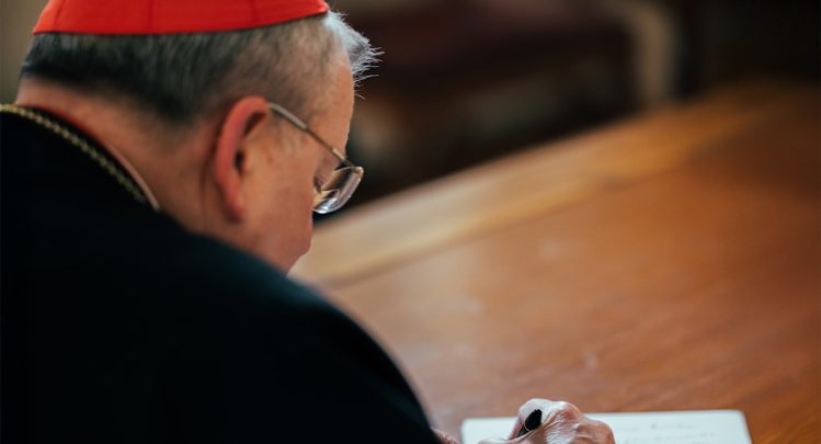 Cardinal Burke Signing a Letter