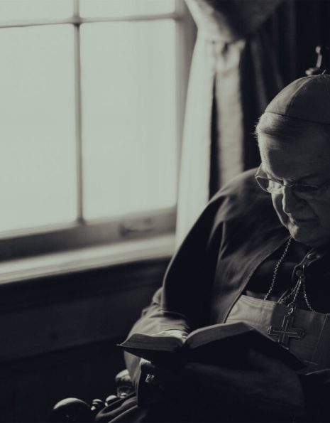 Raymond Leo Cardinal Burke Praying Next to Window